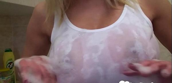  Blonde with great tits teases the camera